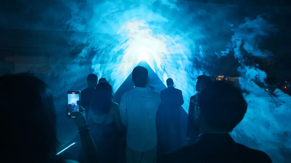 Guests among blue light installations at Nuanu in the evening